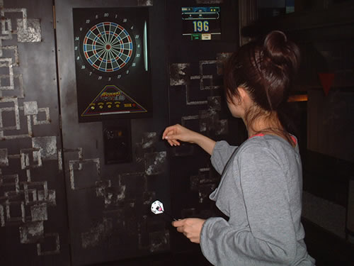 Kumi playing darts